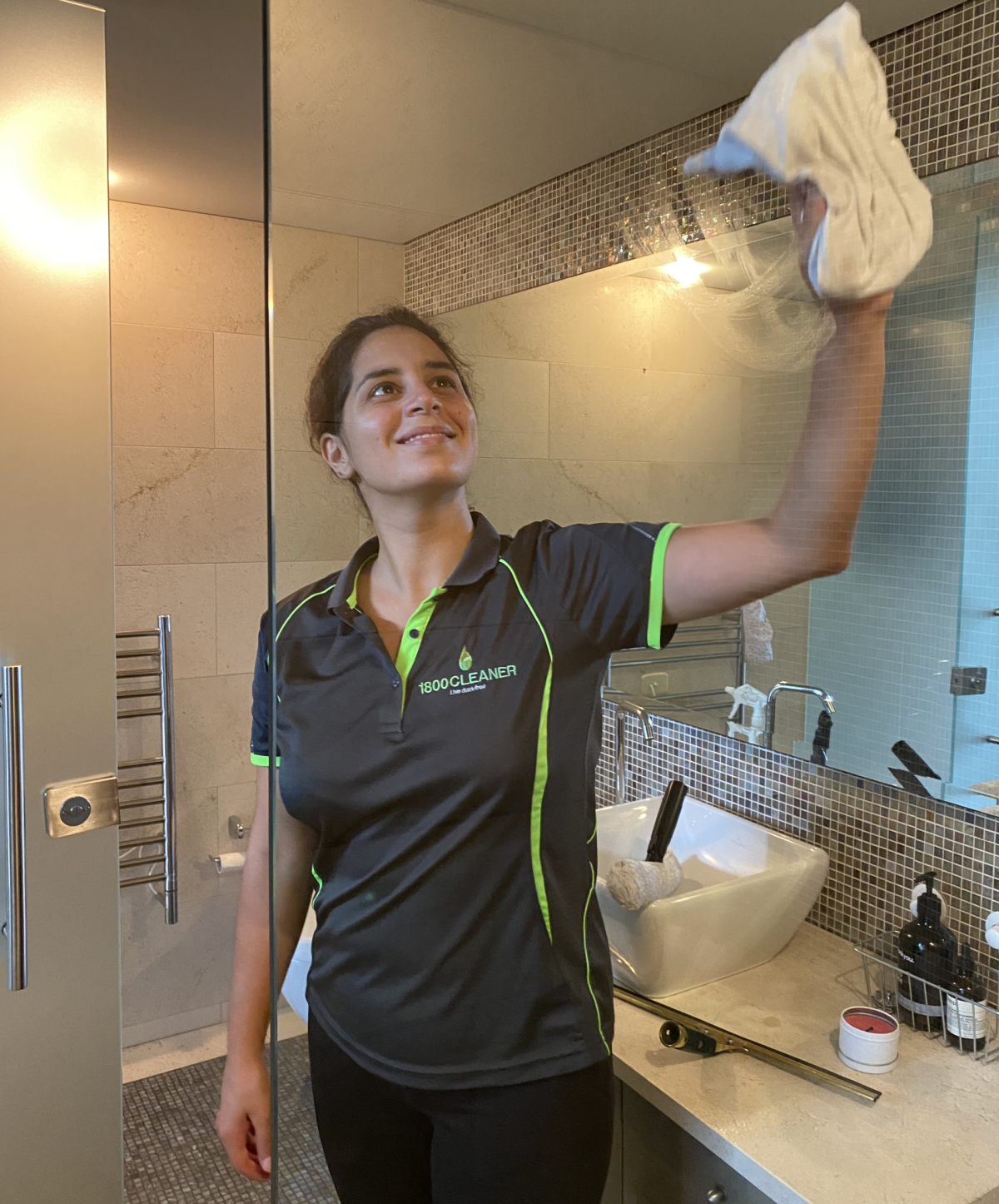 Girl cleaning bathroom and enjoying the many benefits of working with 1800 CLEANER