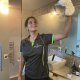 Girl cleaning bathroom and enjoying the many benefits of working with 1800 CLEANER